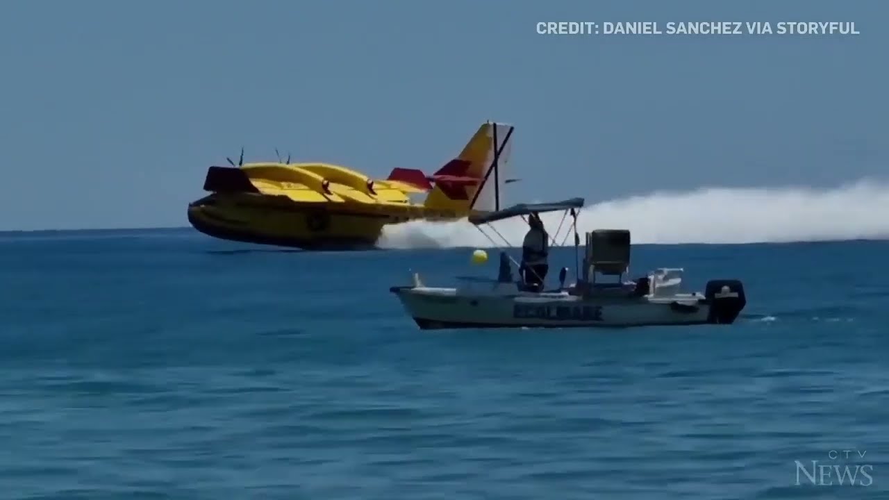 Europe wildfires: Water bomber refills off Spanish beach