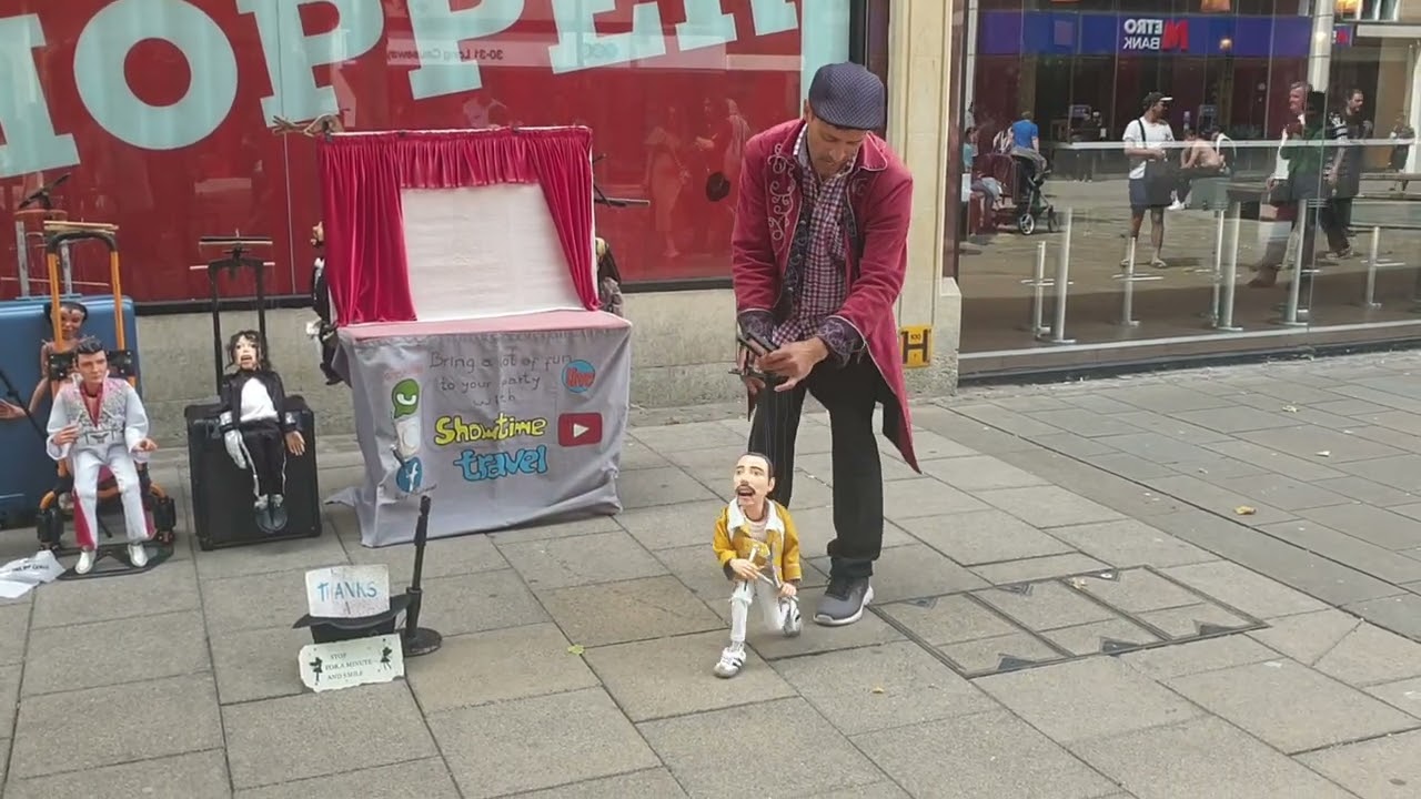 Musician standing outside Burger King with Freddie Mercury & Michael Jackson dolls.
