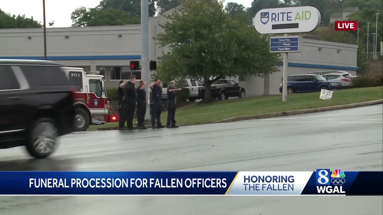 Folks at the midway point of the procession showing their support for the three officers ambushed...
