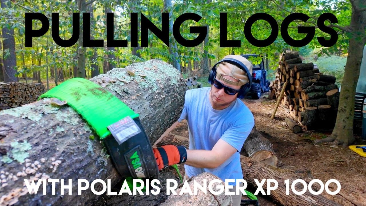 Polaris Ranger pulling firewood logs with Rhino USA tow strap