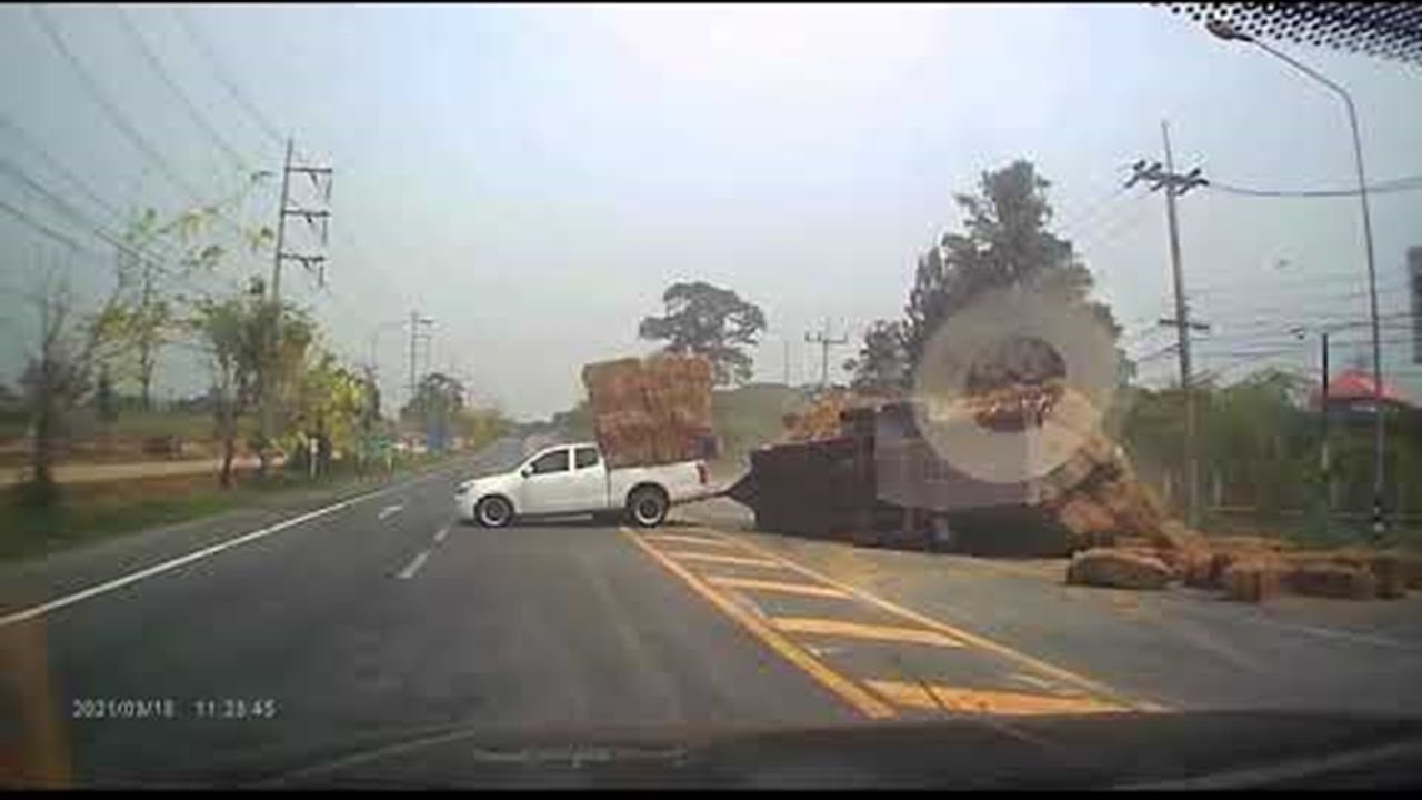 Truck Hauling Massive Straw Load Takes Turn too Fast || ViralHog