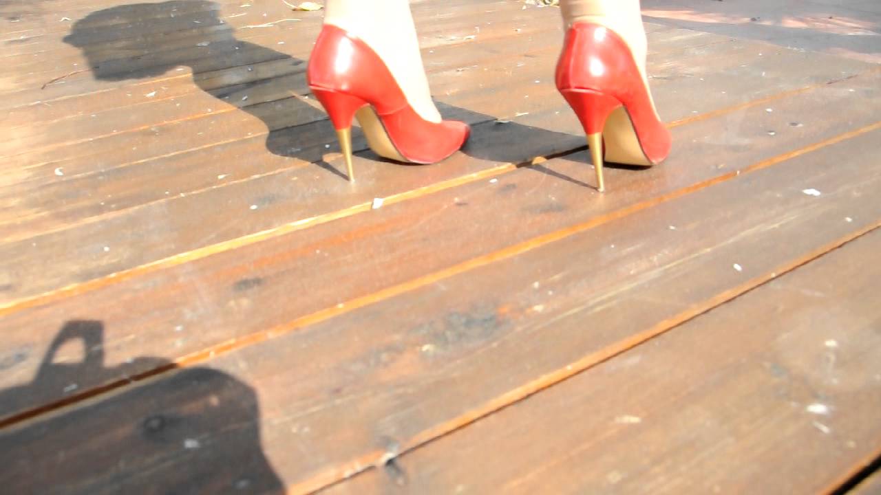 METAL HIGH HEELS ON WOODEN FLOOR