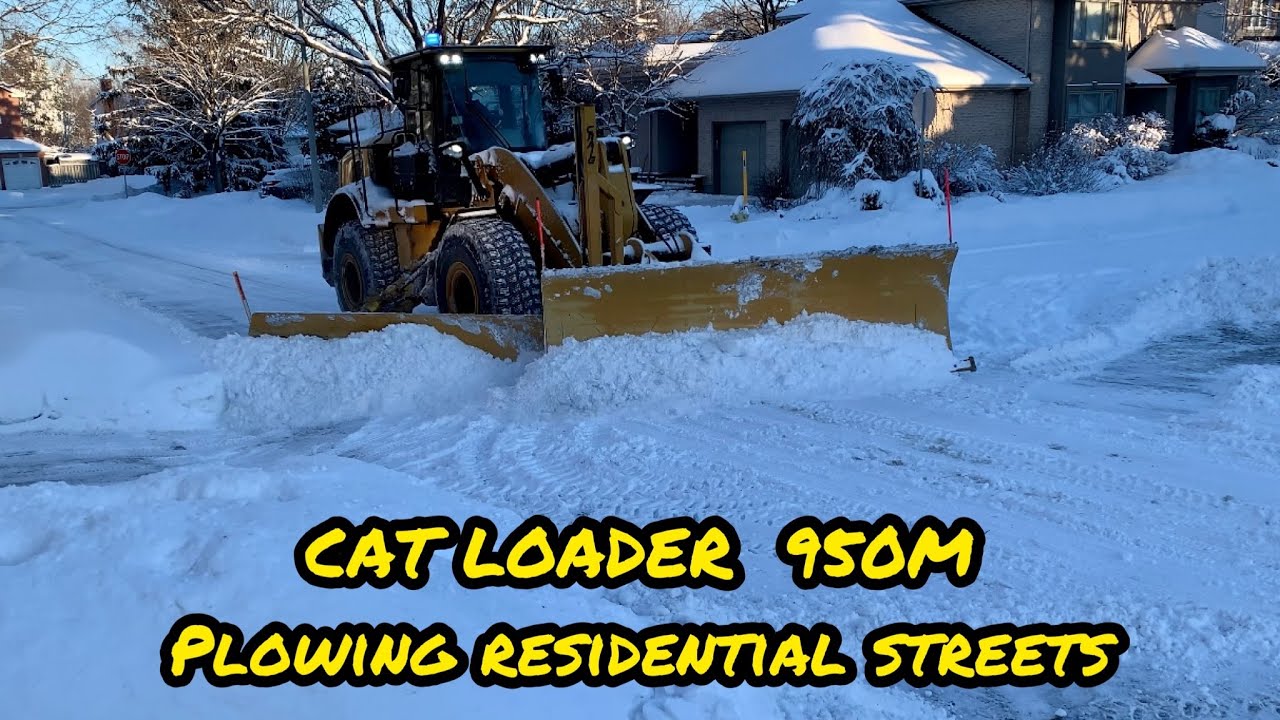 Plowing Residential streets with a Cat loader 950M and a wing blade