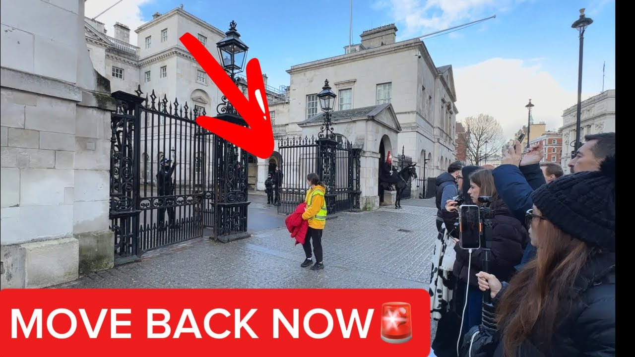 “Crowd Control in Action: Police Ask Tourist to Step Back”