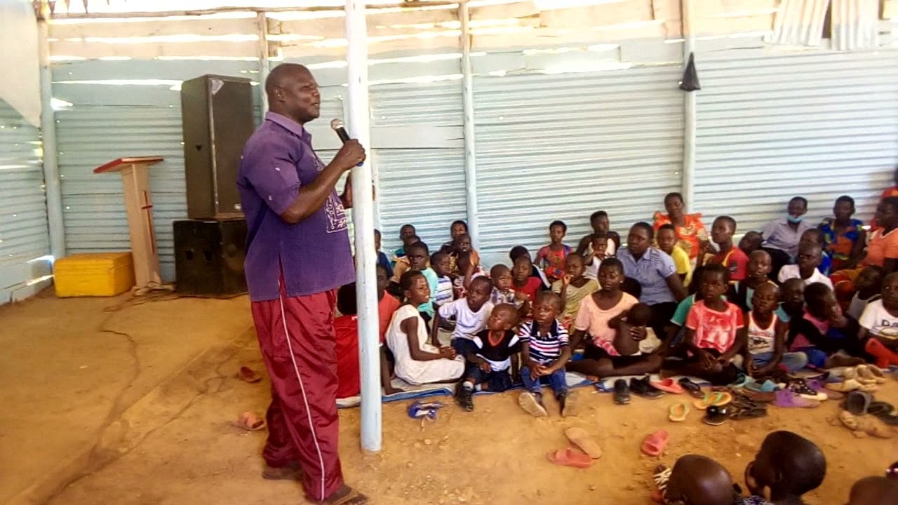 AMAZING GRACE CHURCH AND ORPHANAGE KIKYUSA - LUWERO. BISHOP DANIEL MALE IN RUTOMA X-MAS PARTY.