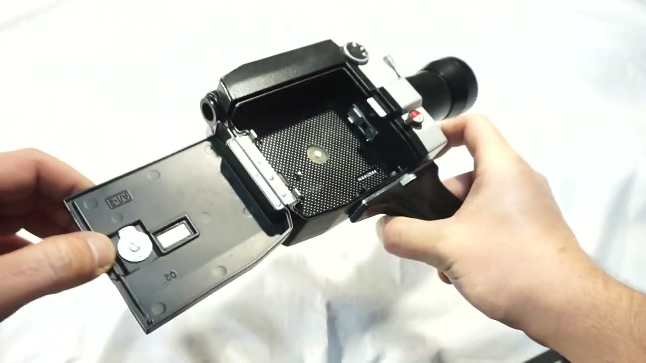 Quarz 1x8S-2 Macro loading Super 8 film and batteries on Super 8 camera Zenit Quarz 1x8S-2