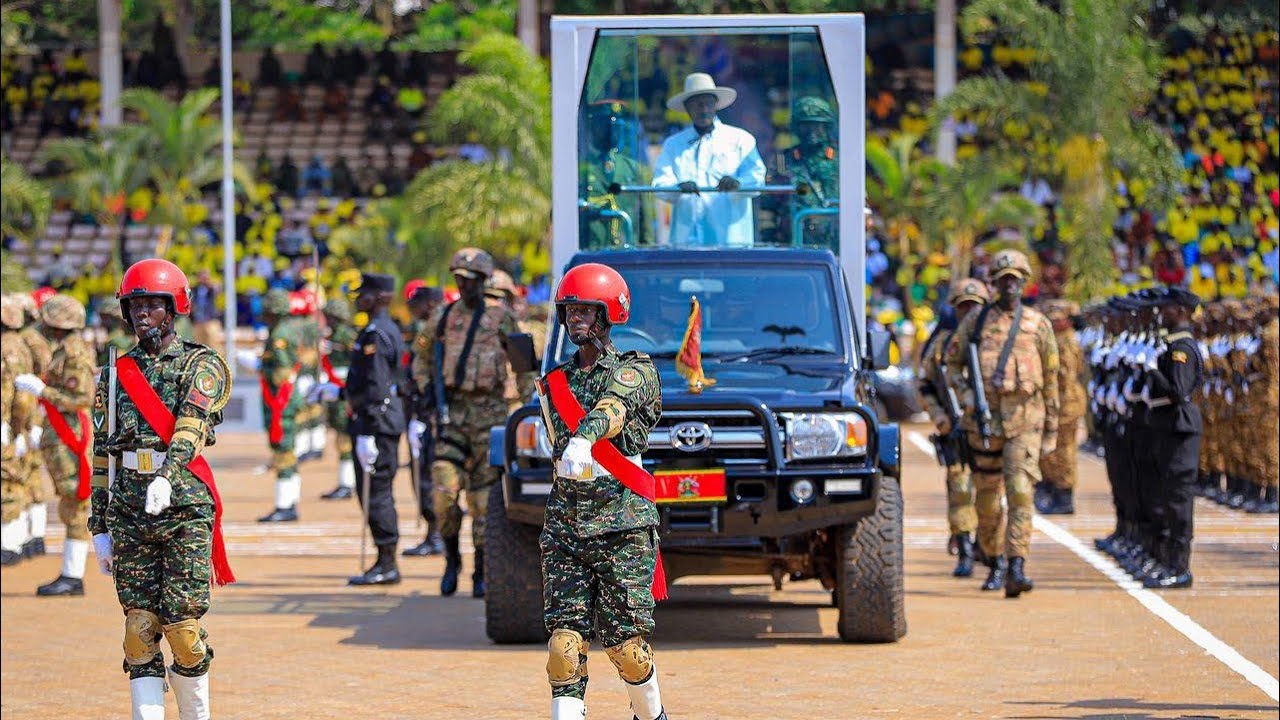 A moment of power: Museveni in a bulletproof glass car inspects security forces parade at Kololo