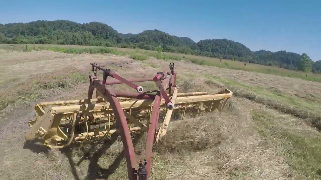 Raking hay with a New Holland 256 Rolabar rake