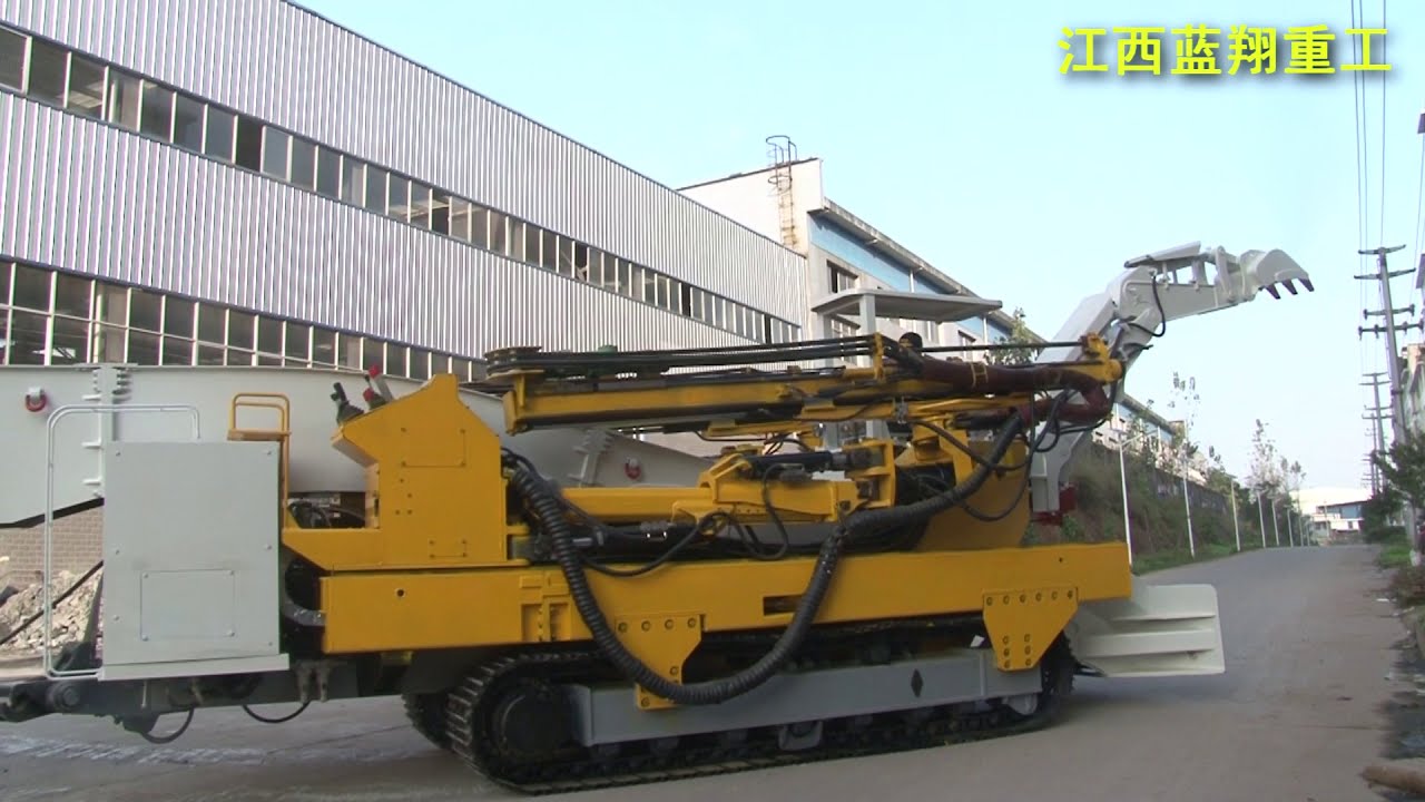 Function demonstration in simulated tunnel of double boom loading, excavating, drilling and bolting