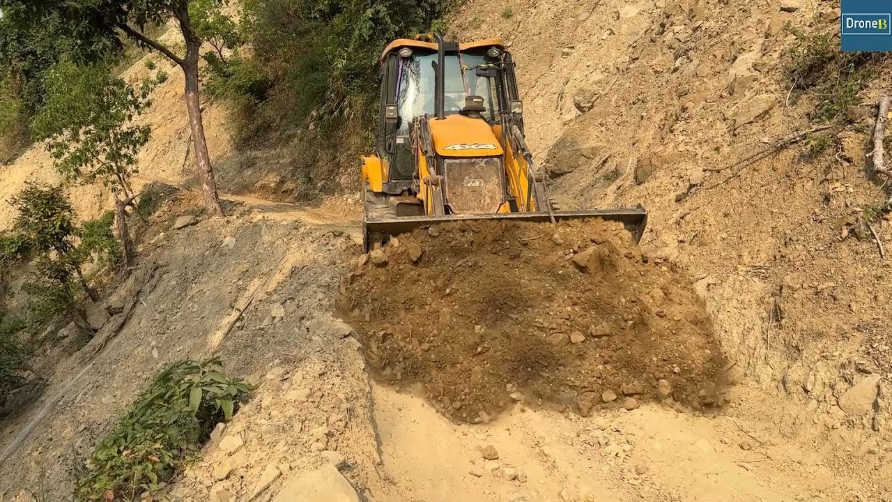 Dry Rocky Mountain Road-Reworking for Smoothness with JCB Backhoe