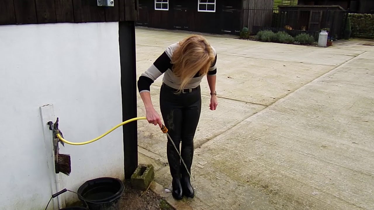 Video 1b   Putting horses out - Taster (riding boots, jodhpurs, wetlook, hosepipe, water,  woman)