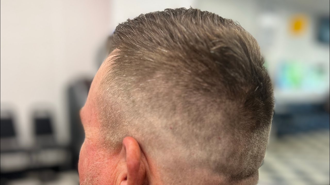 Demonstrating clipper over comb for the top section with Casey