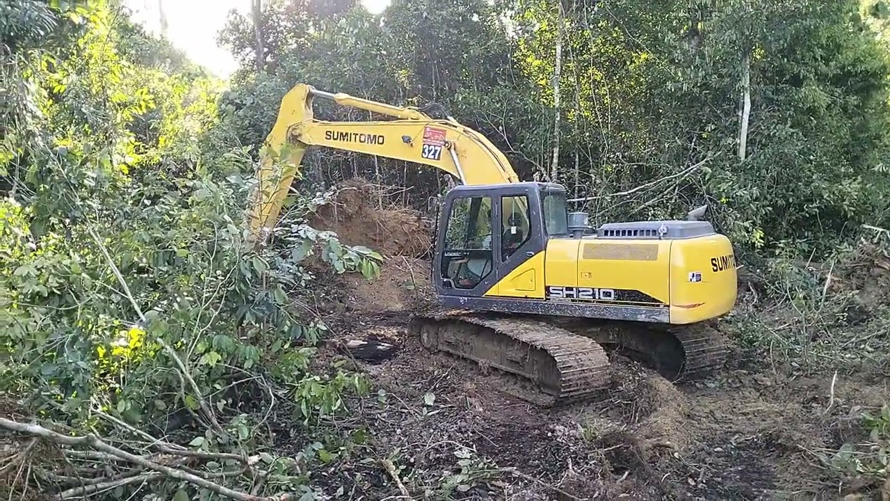 Excavator SUMITOMO SH210,Process to pave the area to make a trench