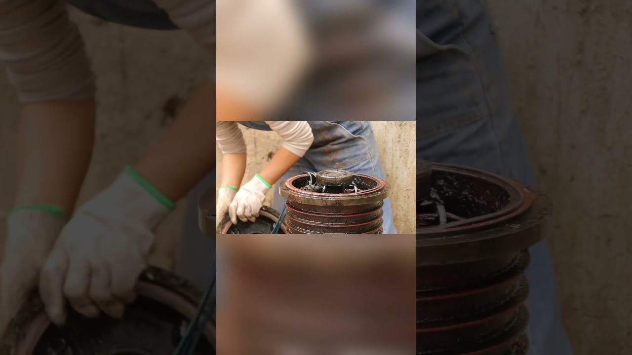 A talented girl repairs a tracked machine missing parts. 