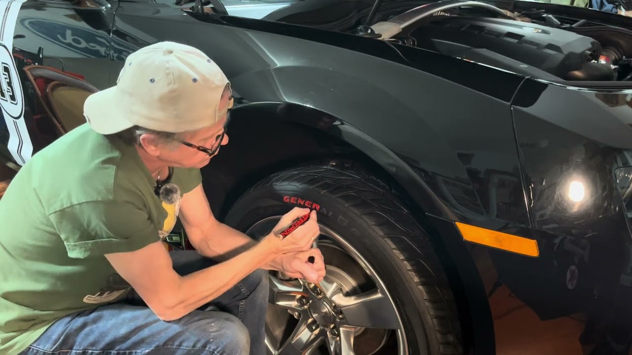 Applying The Tire Pen product on the front passenger side tire.