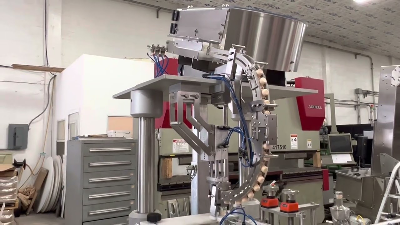 T-cork Automatic Machine Placing T-corks on 750 ml liquor bottle by Acasi Machinery