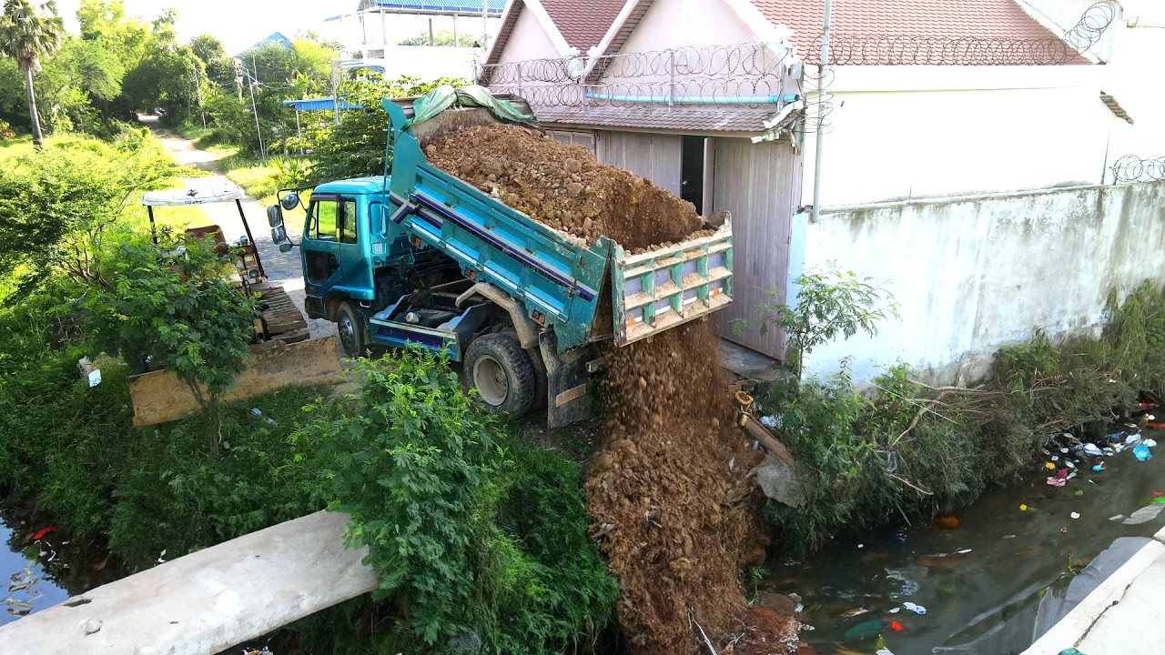 Completed Project Pushing Rock to the flood and sewer in rice field by Turcks and bulldozer