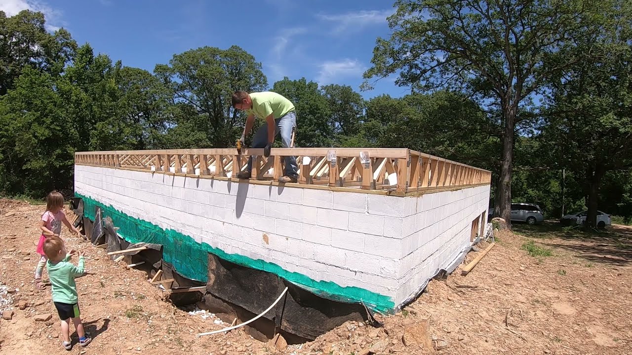 Installing Floor Trusses and building the basement walls