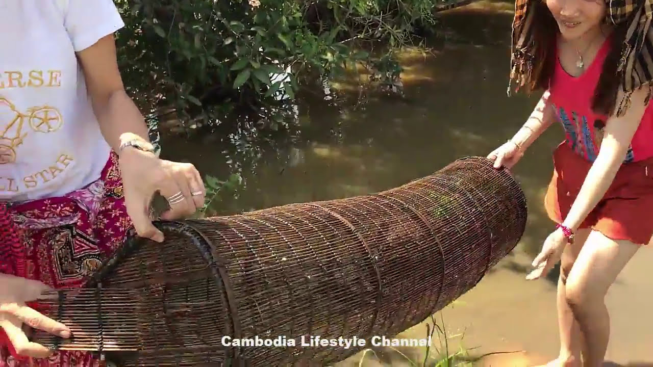 Smart  Cute Girl fishing crabs by bamboo net trap