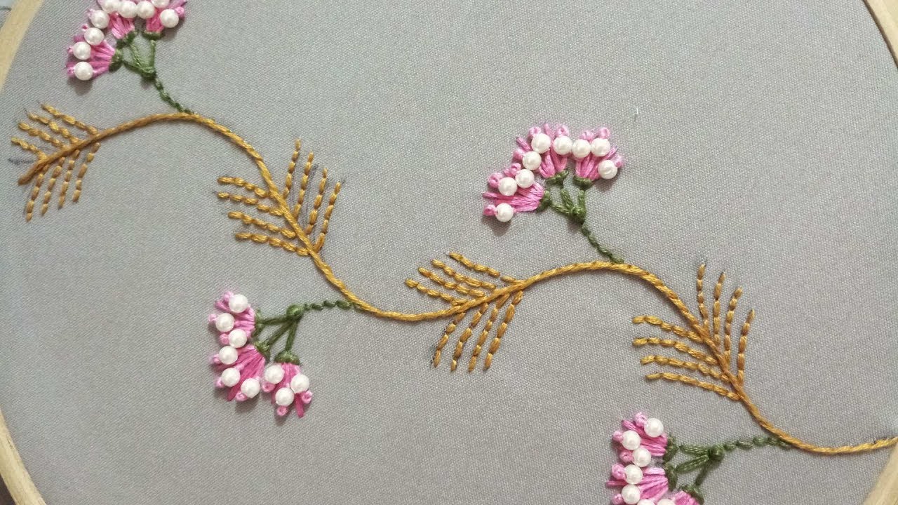 Hand embroidery design  of a creeper plant with pistil stitch and plastic pearls