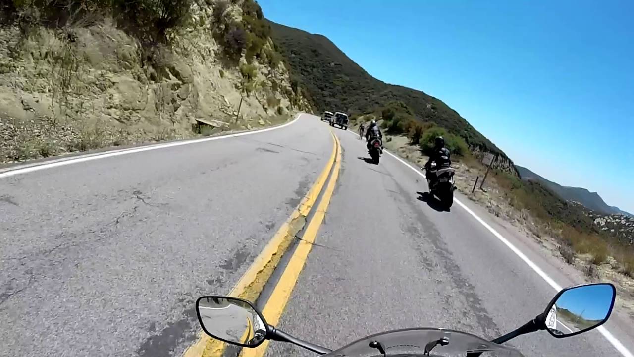 Bicyclist overtakes motorcycles