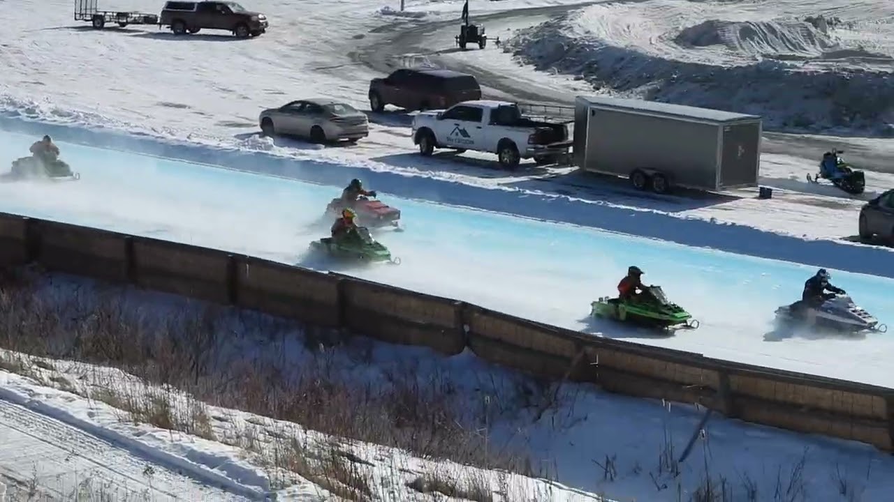 Snowmobile Racer Crashes and slides on Ice at Maritime Snowmobile Championship Racing,Woodstock,NB