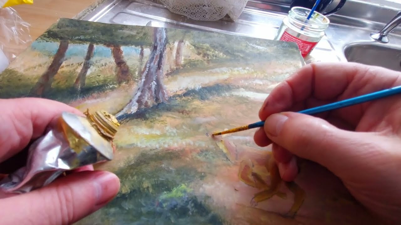 Artist painting in his home studio,  a deer painting 