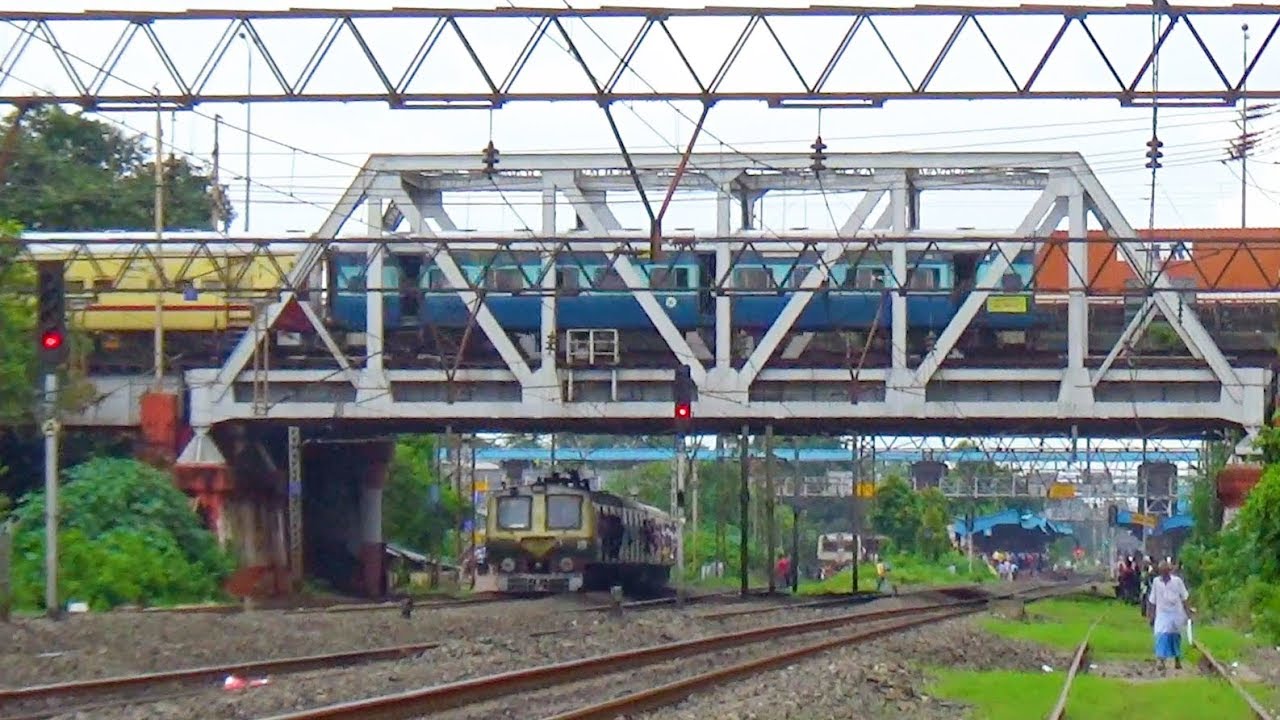 Express Train on Second storied railway track just crossing with ground level Local trains