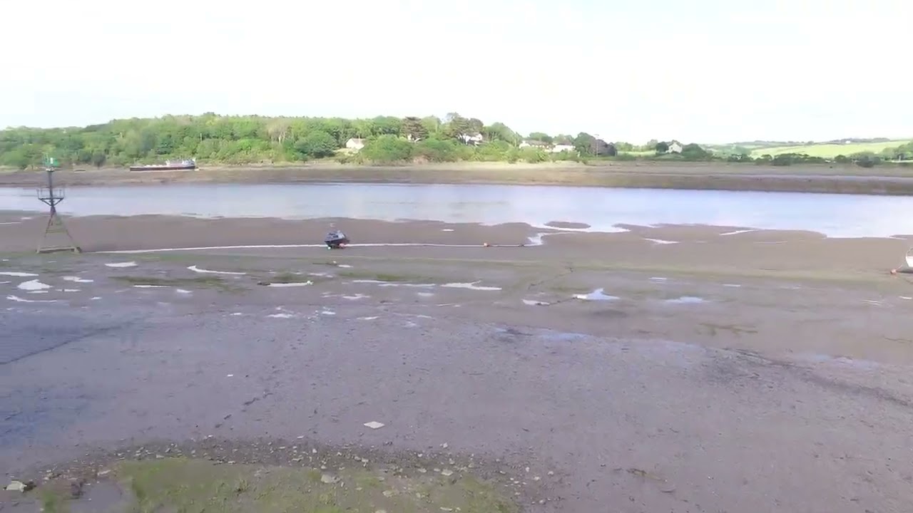 The River Torridge at Lowish Tide, Bideford, North Devon. Albert the Black Speedboat.