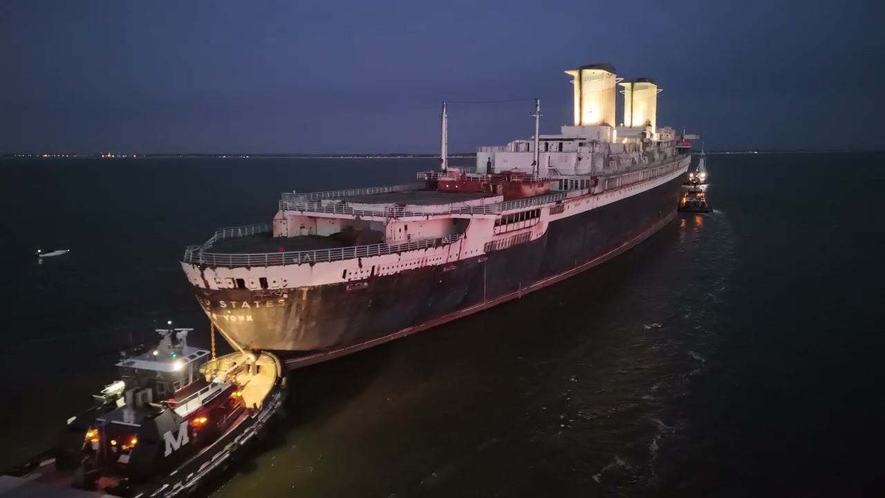 Pass through the illuminated smoke stacks of the SS United States at sunset on the Delaware river