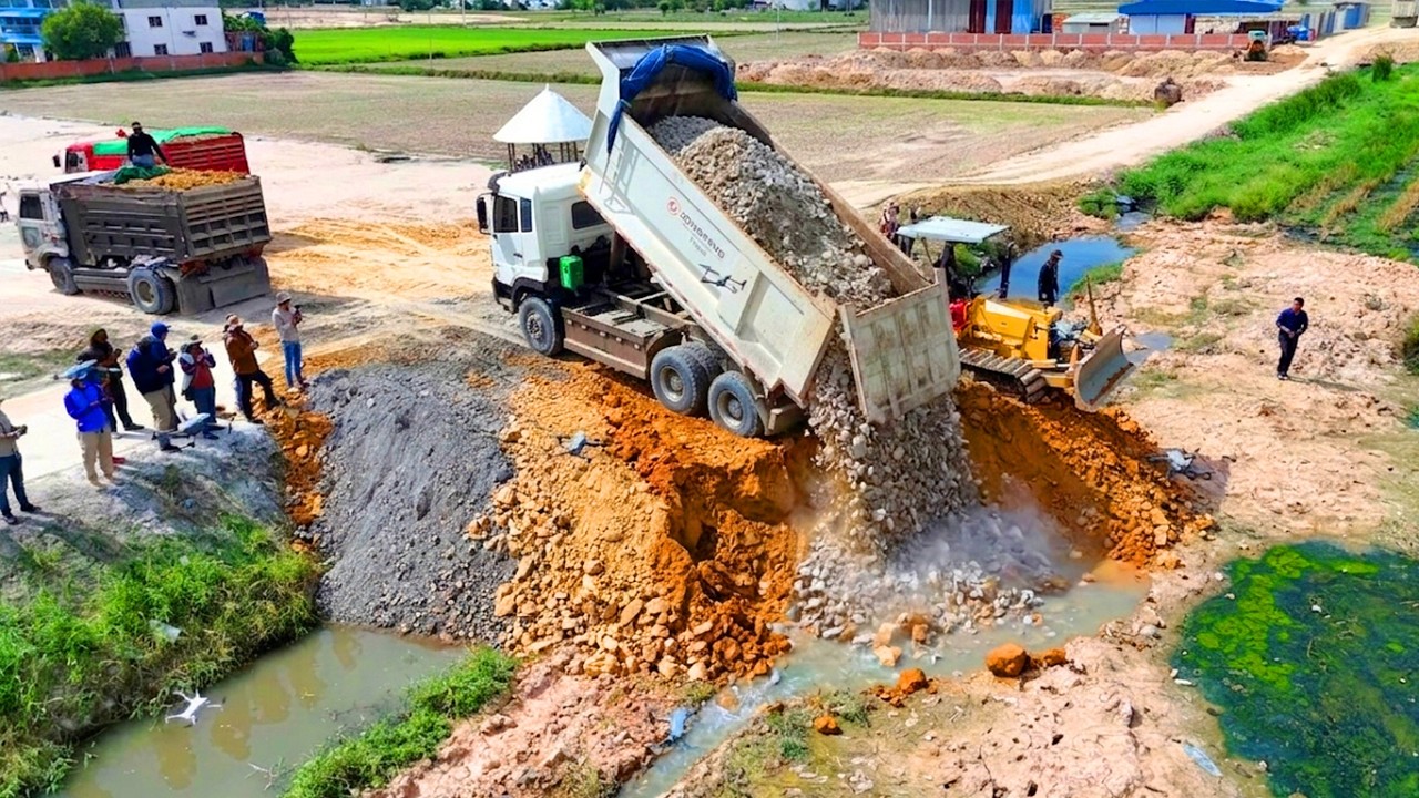 Heavy Machinery in Action Big Truck Dumping Soil to Fill a Canal