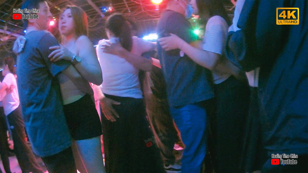 Grandpa dances with his beautiful partner. There are many beauties in the ballroom.