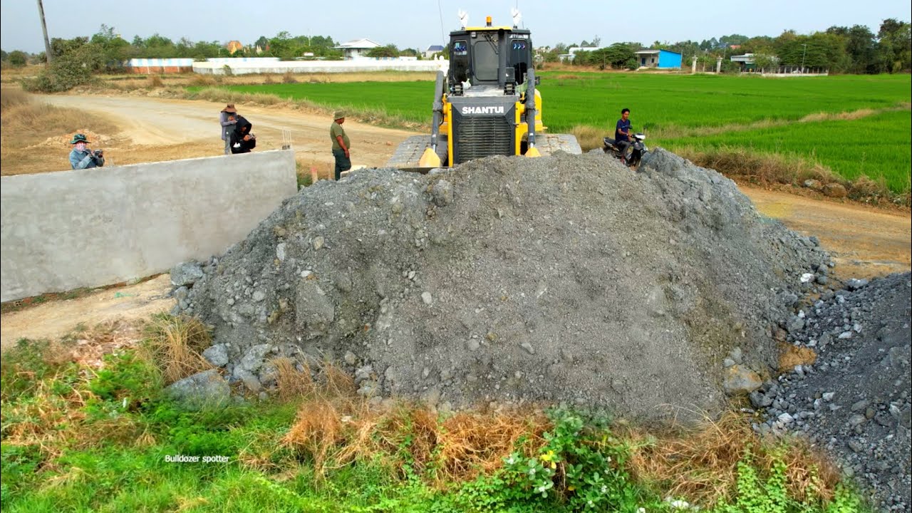 New project landfilling by wheel 10 Dump truck unloading rock and Heavy bulldozer pushing rock fill