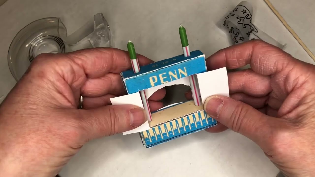 Loading a scroll in a birthday candle crankie box