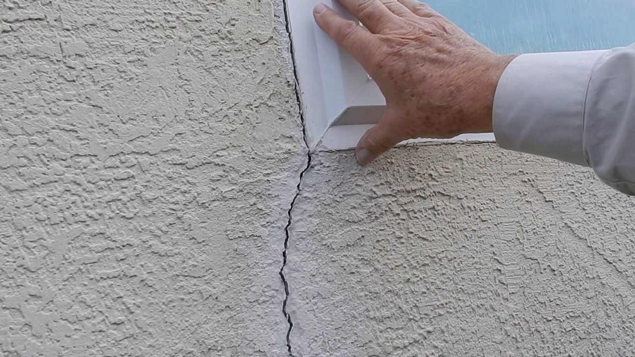 Stucco wall & small crack at window explanation.
