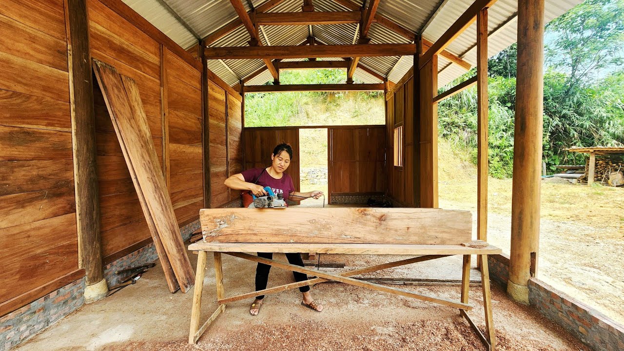 The process of a single woman building a sturdy wooden house by herself.