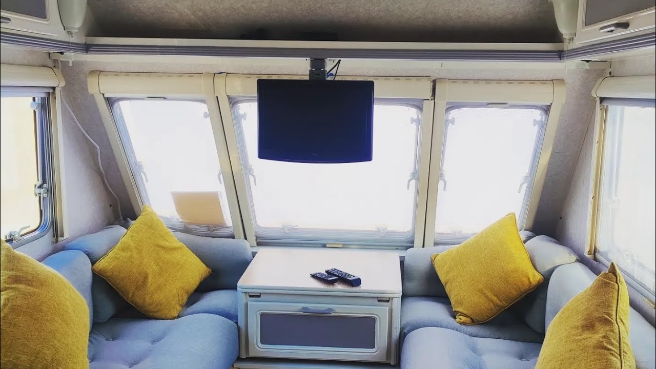 Caravan TV installation with tilting adjustable bracket.