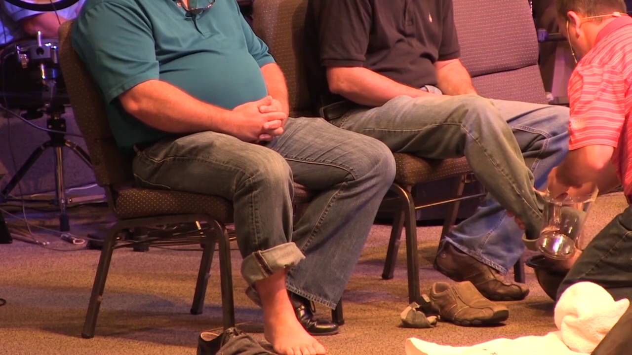Pastor washes feet of police officers and church member