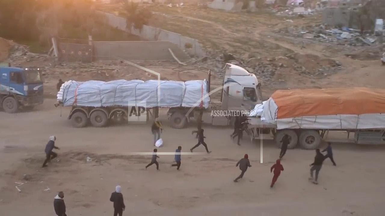 Sacks of supplies taken as aid trucks pass through Rafah