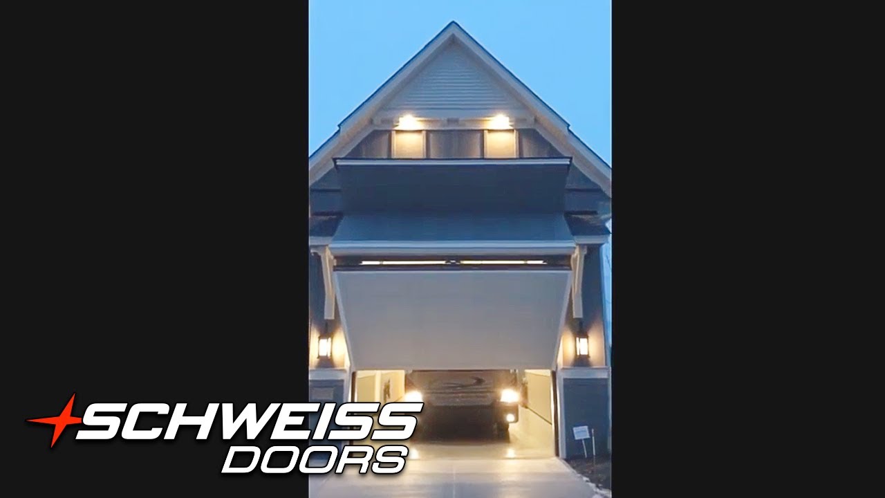 Home with Hidden RV Port and a Schweiss Bifold Garage Door at night
