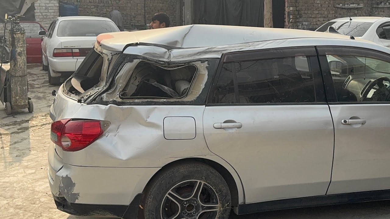 Damaged Nissan Wingroad with Front-End Collision in AutoMaster Workshop