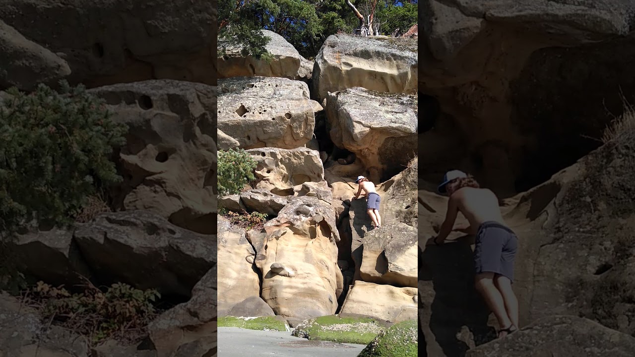 Sucia island. Climbing the shallow bay caves