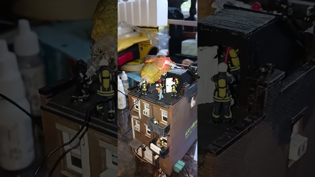working on a building on fire and the firemen fighting it.