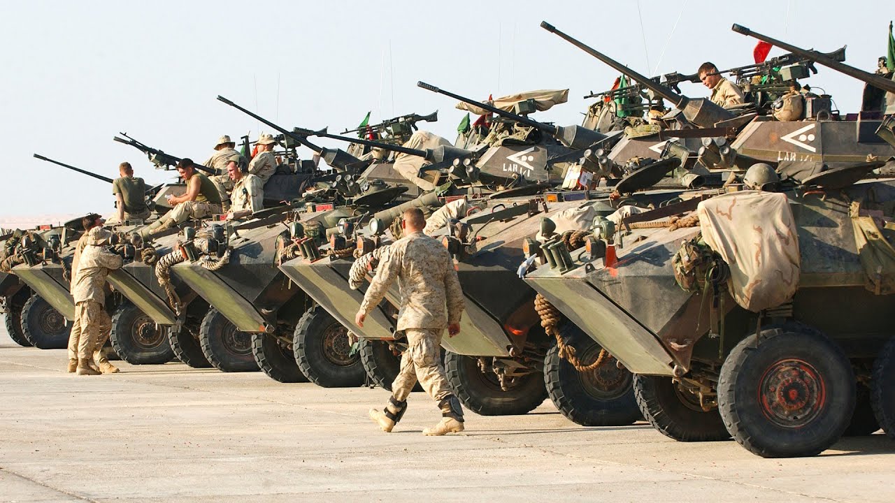 U.S. Marines loading and unloading light armored vehicles from C-17 Globemaster cargo planes
