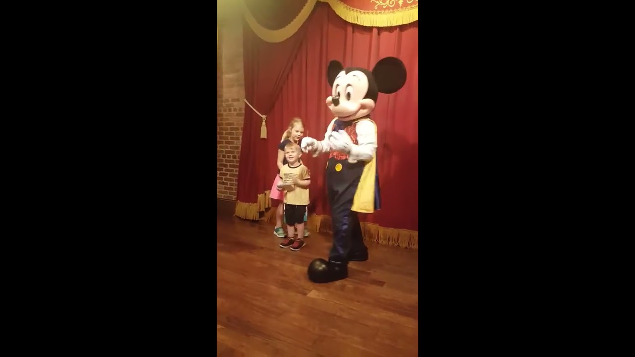 Oh boy!!  Caitlin & Jackson meet and talk with Mickey Mouse!!
