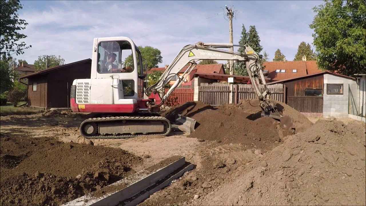 Takeuchi TB 135 leveling topsoil
