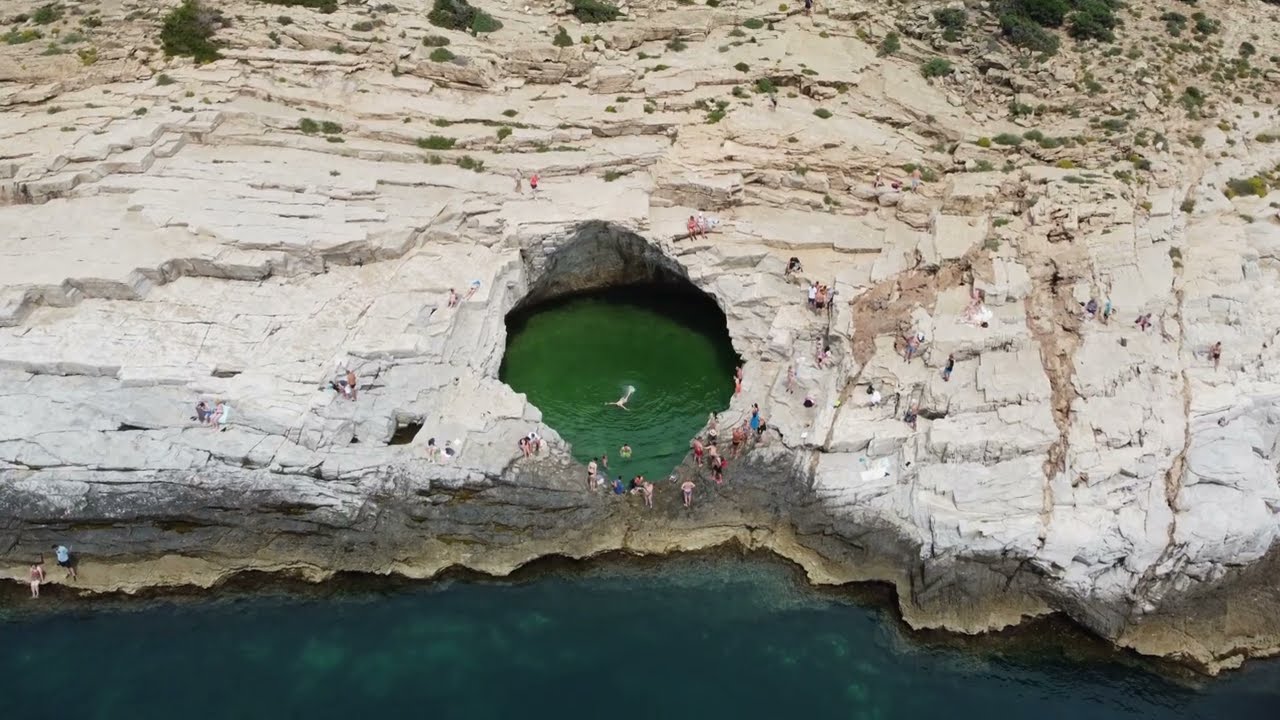 Giola.The natural stone pool from Thassos.Turistic boat.Aegean Sea.Dji Mini 2