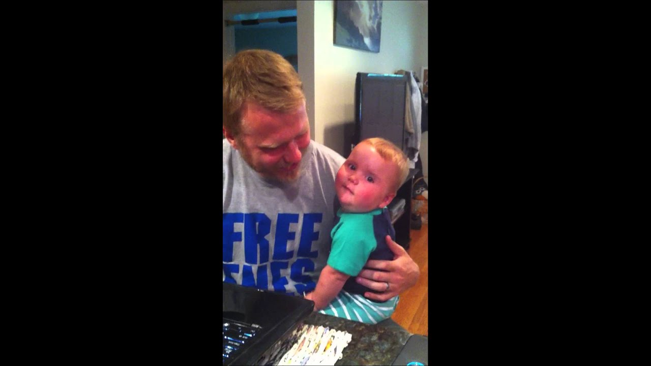 Baby laughing at fly swatter