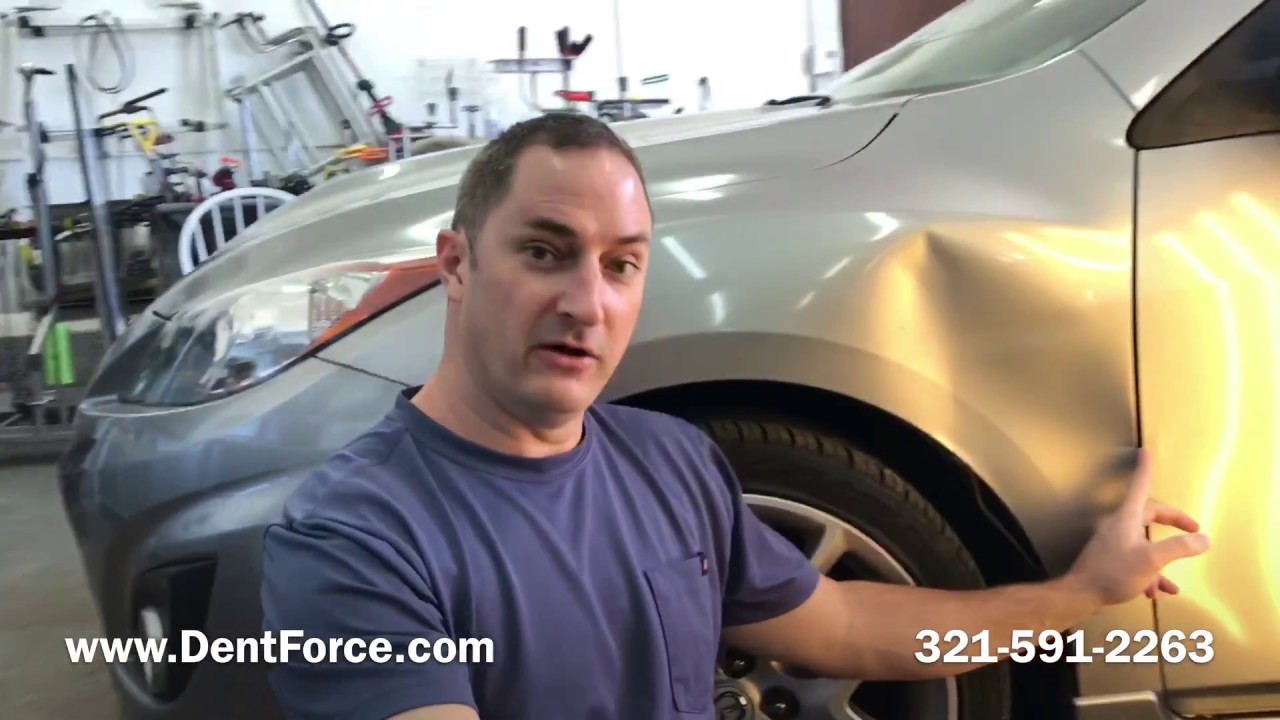 Huge dent in a Mazda 3. Paintless dent Repair in Merritt Island, Cocoa, Melbourne, Titusville.