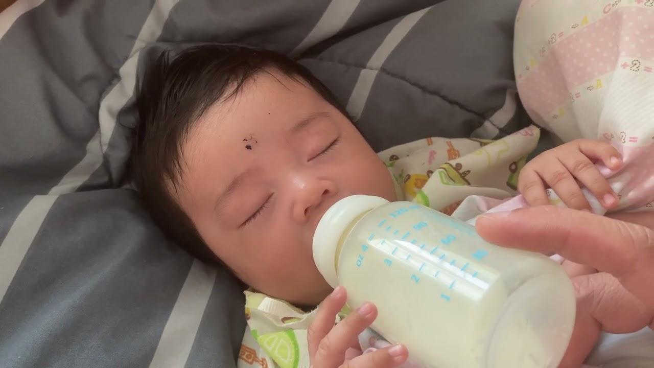 Baby sleeping and drinking milk at morning 